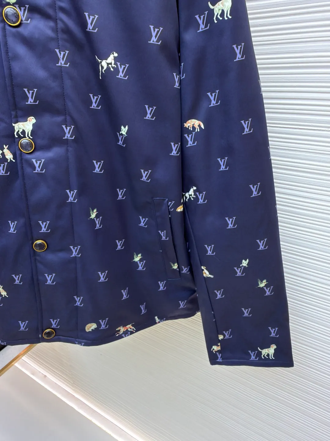 LOUIS VUITTON corduroy lapel animal print jacket ●Original version: 25500 purchased and developed ●Item number: 1681800-C00 ●Fabric: high-density polyester nylon fabric ●Technology: digital direct printing ●Color: blue ●Type: fitted version ●Weight: about 805 grams ●Size: 46-48-50-52 ●Description: This LOUIS VUITTON corduroy lapel jacket is made of high-density twill fabric base, and the surface is combined with corduroy texture splicing, taking into account both stiffness and soft touch. The body pattern uses digital direct printing technology to accurately print the LV logo and animal elements on the fabric. The color is full and not easy to fade. The collar is made of contrasting corduroy material, and the positioning and cutting process is used to ensure the alignment of the splicing; the front placket is equipped with metal buttons, and the surface of the buttons is matte-plated for a refined and durable texture. The version has a loose lapel design, and the shoulders and armholes are three-dimensionally cut, with precise stitching to improve the fit. The overall process pays attention to the details of pattern positioning and fabric splicing. The edges are overlocked to take into account brand recognition and practical wearability. It is recommended to hand wash to protect the printing and fabric texture. The overall wiring is straight and delicate, the fabric is comfortable and soft, and the color is consistent without color difference. It can be matched with the same style to create a fashionable look and control various occasions. Customized accessories, complete with three standards, same style for men and women!